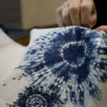 Hand stitching on stitch resist, indigo dyed cotton fabric.