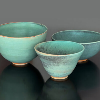 3 ceramic bowls on dark grey background