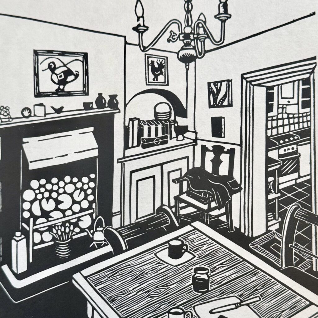 Black and white linocut print of a dining room, with table and chairs, large fireplace and view through to a kitchen