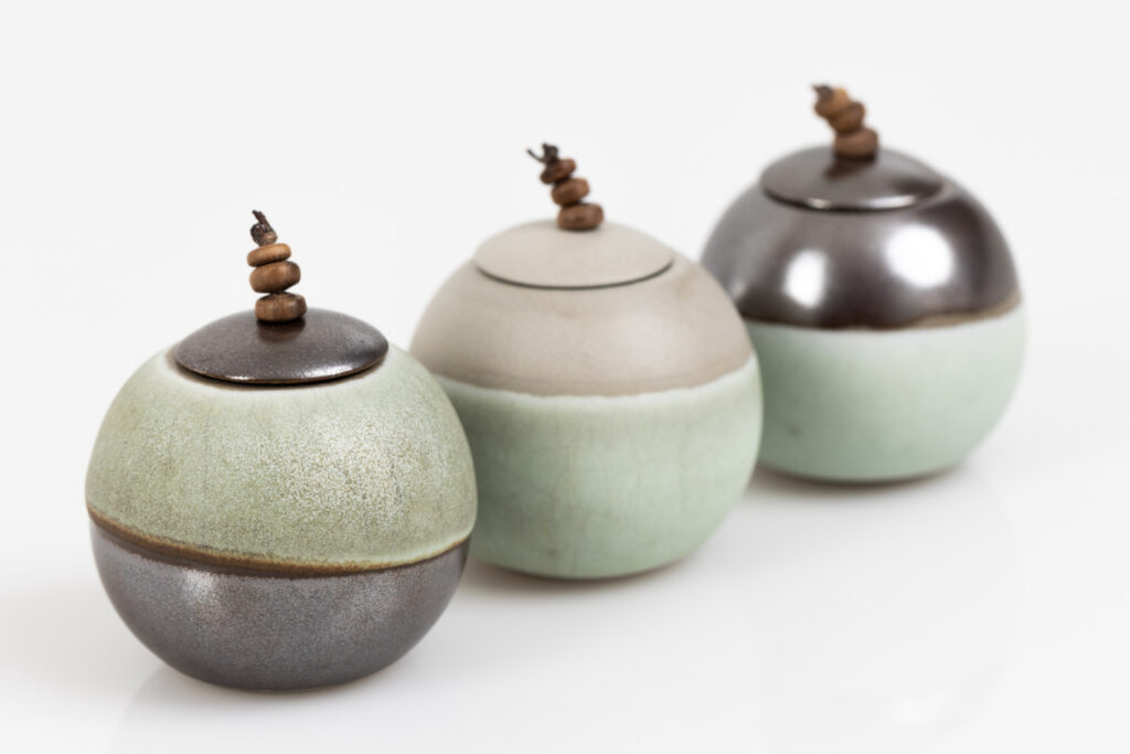 small stoneware lunar sphere pots with beaded lids